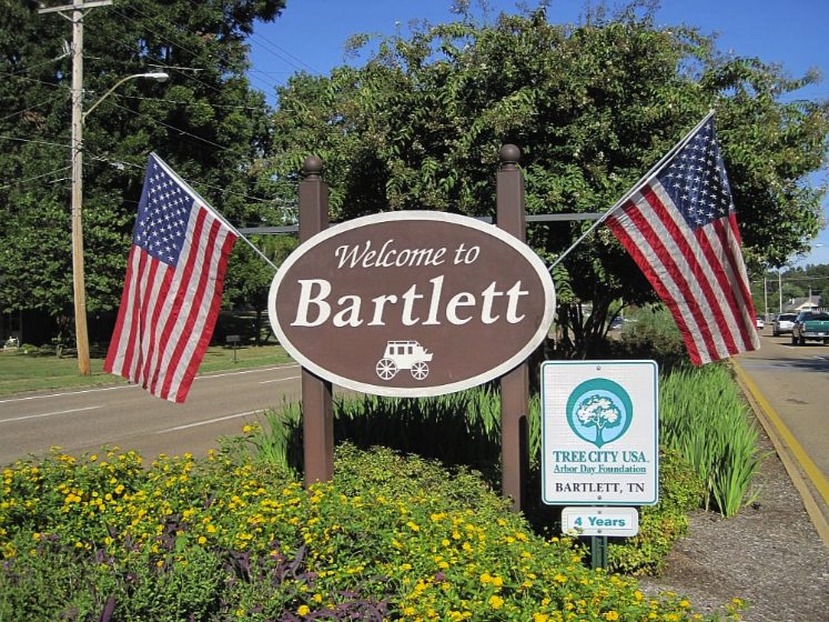 Welcome to Bartlett sign with American flags