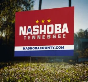 Nashoba Now yard sign in a yard